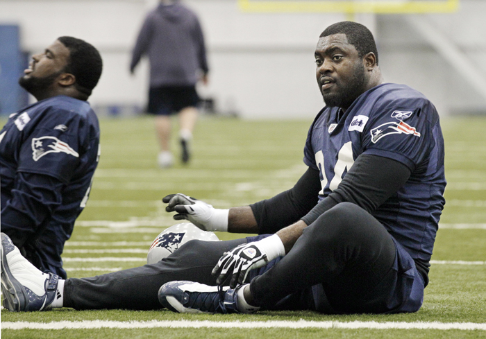 New England Patriots defensive end Shaun Ellis stretches during practice on Wednesday in Indianapolis.