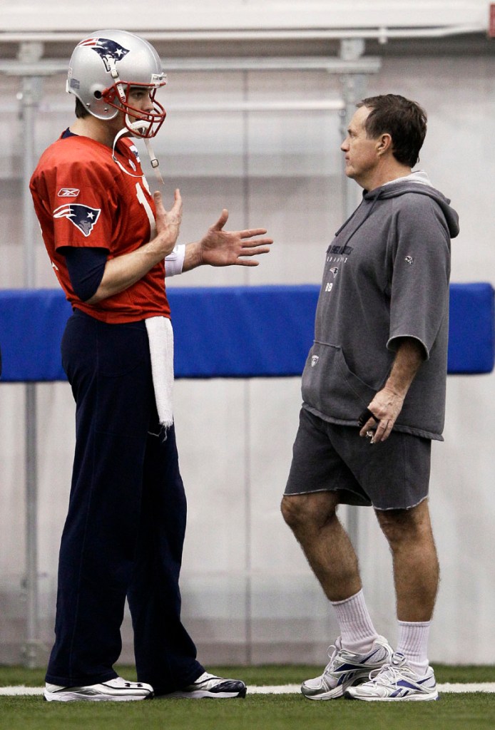 New England Patriots quarterback Tom Brady, left, talks with head coach Bill Belichick during practice on Thursday in Indianapolis. The Patriots are scheduled to face the New York Giants in the NFL football Super Bowl XLVI today.