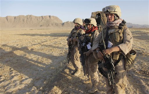 In this 2009 photo, U.S. Marine Female Engagement Team members Lance Cpl. Mary Shloss, right, of Hammond, Ind., Sgt. Monica Perez,, center, of San Diego, Calif. and Cpl. Kelsey Rossetti, of Derry, N.H. begin their patrol in the Helmand Province of Afghanistan. The team's mission was to engage local Afghan women to find out and address their concerns.