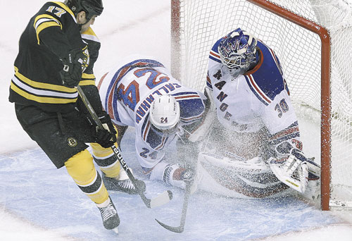 NICE STOP: New York Rangers right wing Ryan Callahan (24) dives in the crease as goalie Henrik Lundqvist protects the net against Boston Bruins left wing Milan Lucic, left, in the first period Tuesday in Boston.
