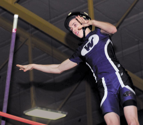 UP AND OVER: Waterville’s Devin Burgess won the Class B state championship in the pole vault with a leap of 13-feet on Monday in Bates College in Lewiston.