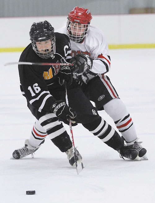 ONE MORE CLASH: MHW forward Tyler Bryant (16) battles for the puck with Cony High School’s Austin Davis during the first period earlier this season in Kents Hill. The two teams will meet again in the Eastern Class A quarterfinals at 4 p.m. today at Kents Hill.