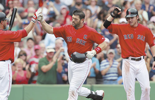 Red Sox catcher Jason Varitek, center, celebrates a two-run homer last year against Oakland. It's possible the beloved team captain has played his last game with the Red Sox.