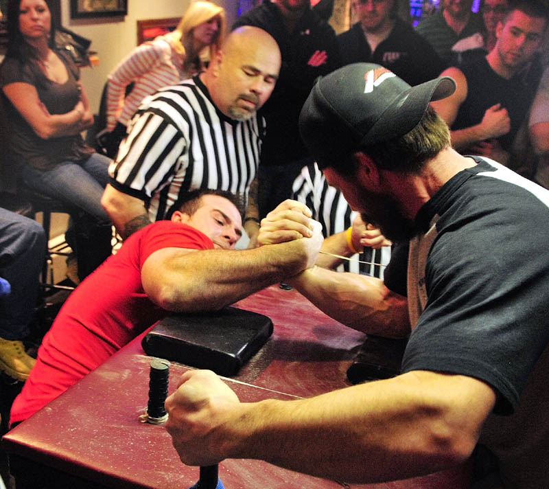 Matt Bouchard, left, of Caribou, and Malcolm Tashjian, of Salem, NH, compete in a 177-198 pound match at the Maine State Arm Wrestling Championships on Saturday night at the Pond Town Tavern in Winthrop.