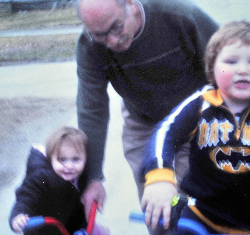 FAMILY FUN: Ernest Sayers is shown in this family photograph of him playing with grandchildren of Janice Gitschier. Sayers' body was found early Sunday in Bingham.