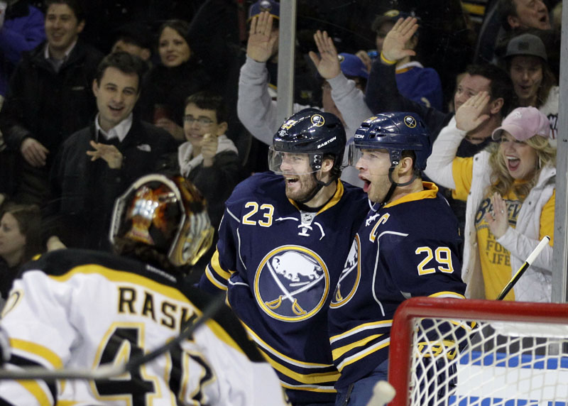 TOUGH NIGHT: Buffalo Sabres forward Jason Pominville, right, celebrates his goal with Ville Leino while Boston Bruins goalie Tuukka Rask looks on during the first period Wednesday night in Buffalo, N.Y. The Bruins lost 6-0.