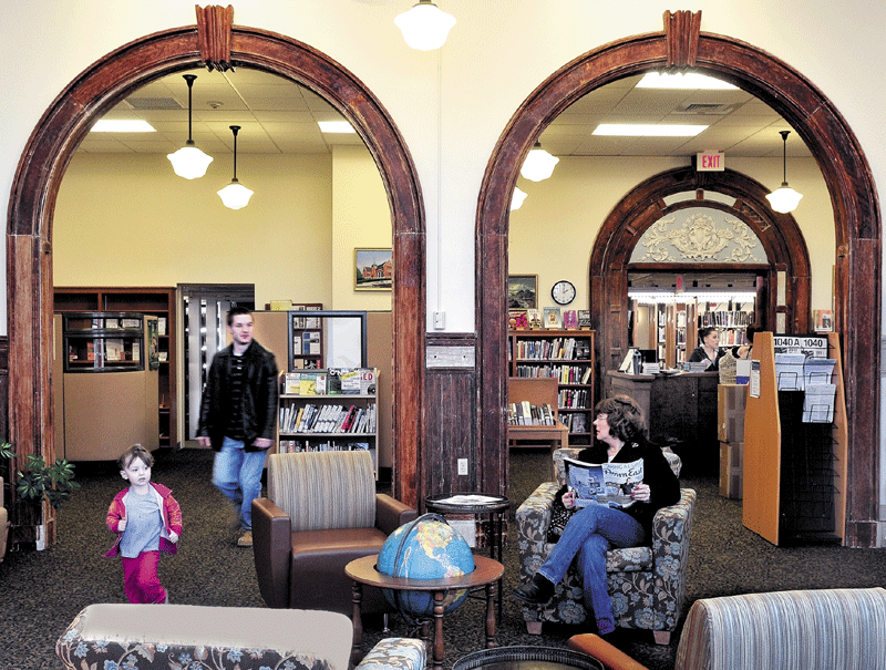 WELL READ: Devan Vance follows his daughter Natalie as Sherry Senter looks up from reading in the renovated Waterville Public Library. The library is the recipient of the 2011 Community Service Project of the Year award from the Mid-Maine Chamber of Commerce.