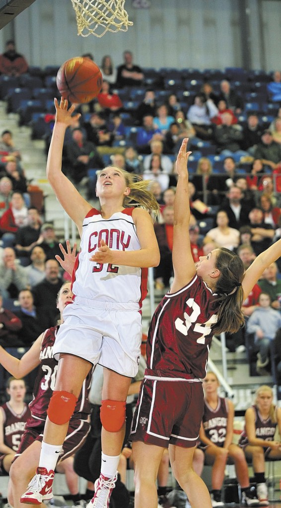 Staff photo by Joe Phelan Cony's Mia Diplock goes up for shot over Bangor's Jordan Seekins during the Class A East tournament on Friday night at the Augusta Civic Center.