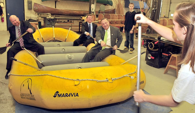 RUB A DUB DUB: Gov. Paul LePage, right, Education Commissioner Stephen Bowen, in back, and Jonathan Nass follow instructions from student Meghan Orchard on how to paddle in a whitewater raft following announcement of education policies at the Somerset Career Technical Center in Skowhegan on Wednesday.