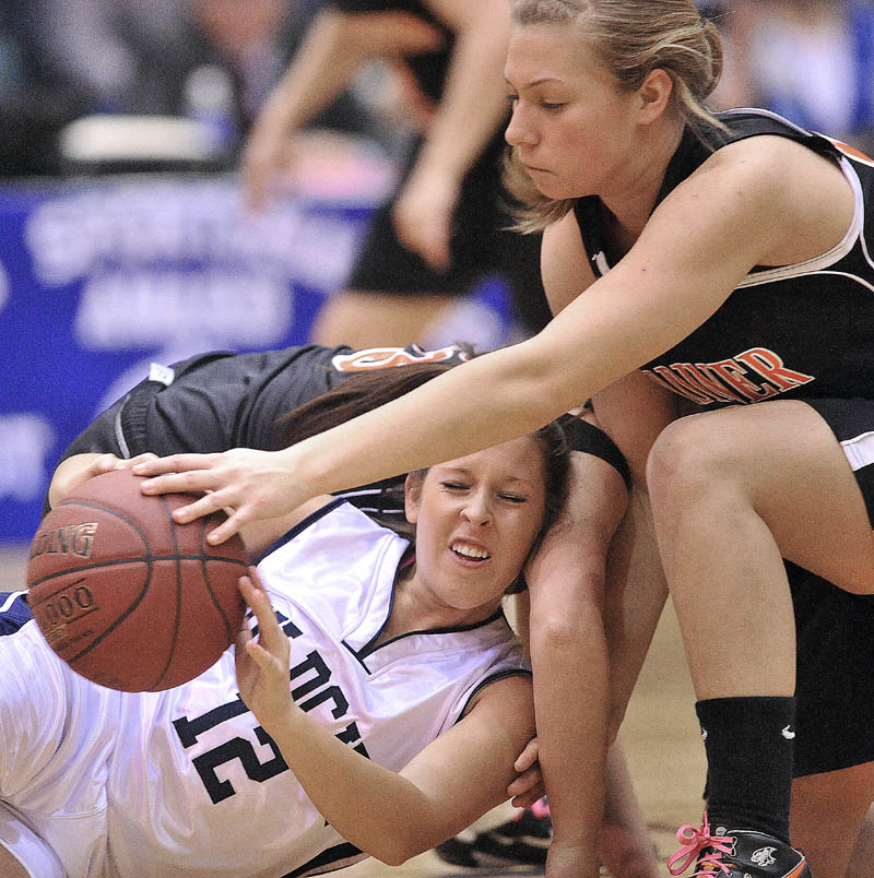 Photo by Michael G. Seamans Gardiner High School's Kelly MaComber, 22, battles for the loose ball with Presque Isle High School's Chelsea Nickerson, 12, in the first half of the Eastern Class B semi-finals at the Bangor Auditorium Wednesday.