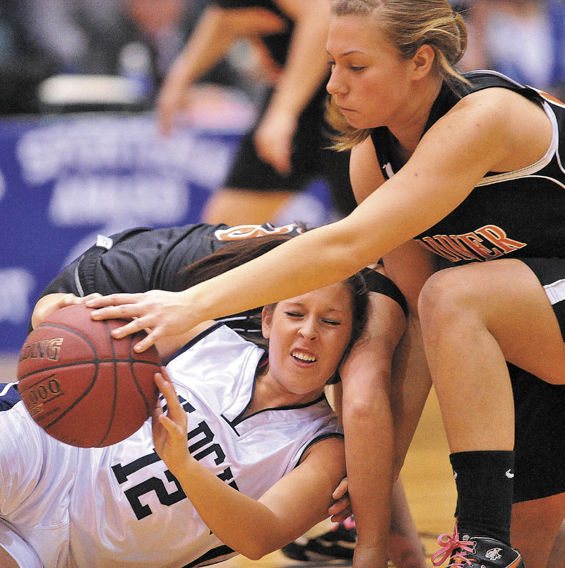 Gardiner High School's Kelly MaComber, 22, battles for the loose ball with Presque Isle High School's Chelsea Nickerson, 12, in the first half of the Eastern Class B semi-finals at the Bangor Auditorium Wednesday.