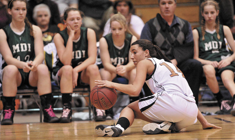 Photo by Michael G. Seamans Gardiner High School guard Jenna Moore, 14, recovers her dribble after recovering the loose ball against Mount Desert Island High School in the second half of the Eastern Class B quarterfinals game at the Bangor Auditorium Saturday. Gardiner defeated MDI 63-38.