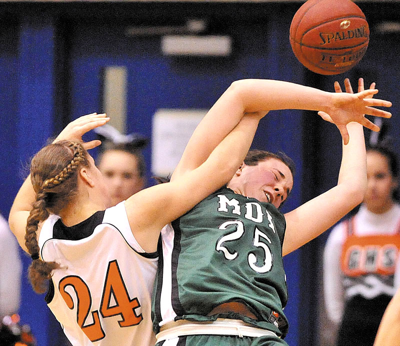 Photo by Michael G. Seamans Gardiner High School's Allyson Day, 24, left, fights for the ball with Mount Desert Island High School's Hannah Shaw, 25, right, in the second half of the Eastern Class B quarterfinals game at the Bangor Auditorium Saturday. Gardiner defeated MDI 63-38.