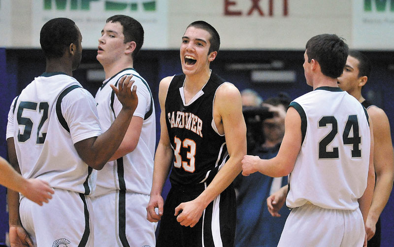 GREAT FEELING: Gardiner Area High School’s Aaron Toman, center, celebrates during the Tigers’ 70-58 victory over Mt. Desert Island in the Eastern Maine Class B final Saturday at the Bangor Auditorium. The Tigers will make their first state championship game appearance Saturday against Yarmouth.