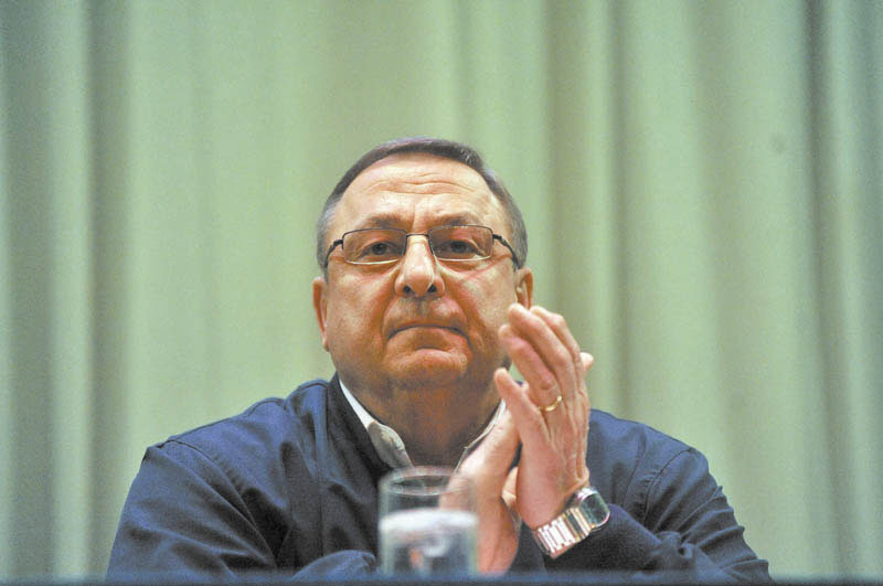 Gov. Paul LePage claps as members of the discussion panel are introduced during a town hall meeting at Madison Junior High School Thursday night.