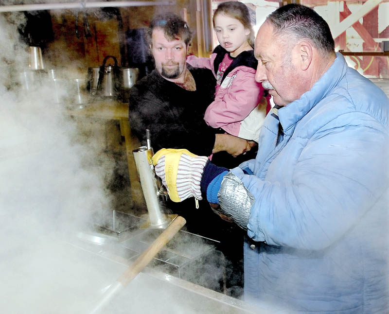 WELL-KNOWN: Clair Lewis tests a container of boiling maple syrup at his Parsons Valley Sugar Farm in Thorndike during a past Maine Maple Sunday event. Lewis died of injuries he sustained while cutting trees on Saturday near the sugar house.