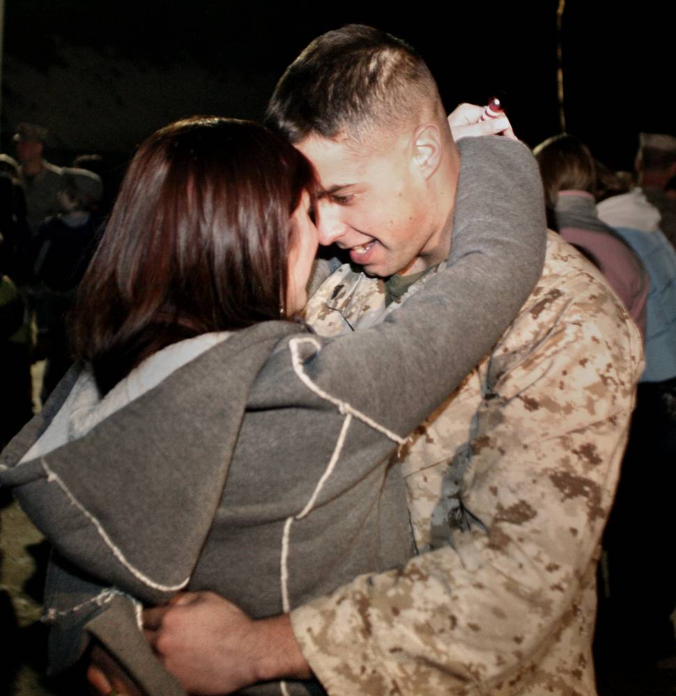 Brittany O'Malley embraces Cpt. David Bolcome Wednesday during the homecoming of Company A, 1st Battalion, 25th Marine Regiment, 4th Marine Division in Brunswick. The couple is from Rockport, Mass.