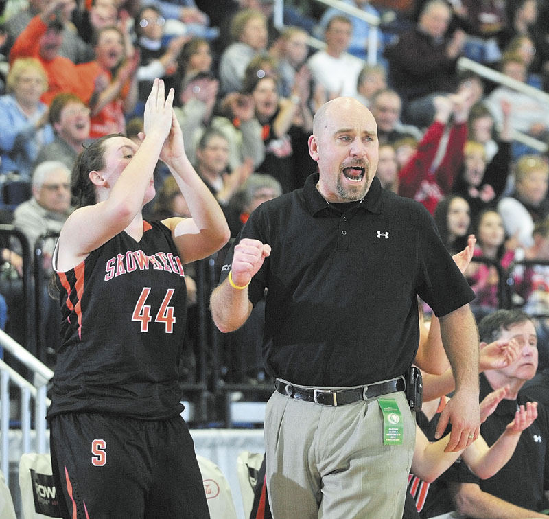 Skowhegan junior forward Andrea Quirion, left, and head coach Heath Cowan celebrate as the Tigers took a fourth quarter lead during the Class A East tournament on Friday night at the Augusta Civic Center. richmond buckfield standish softball