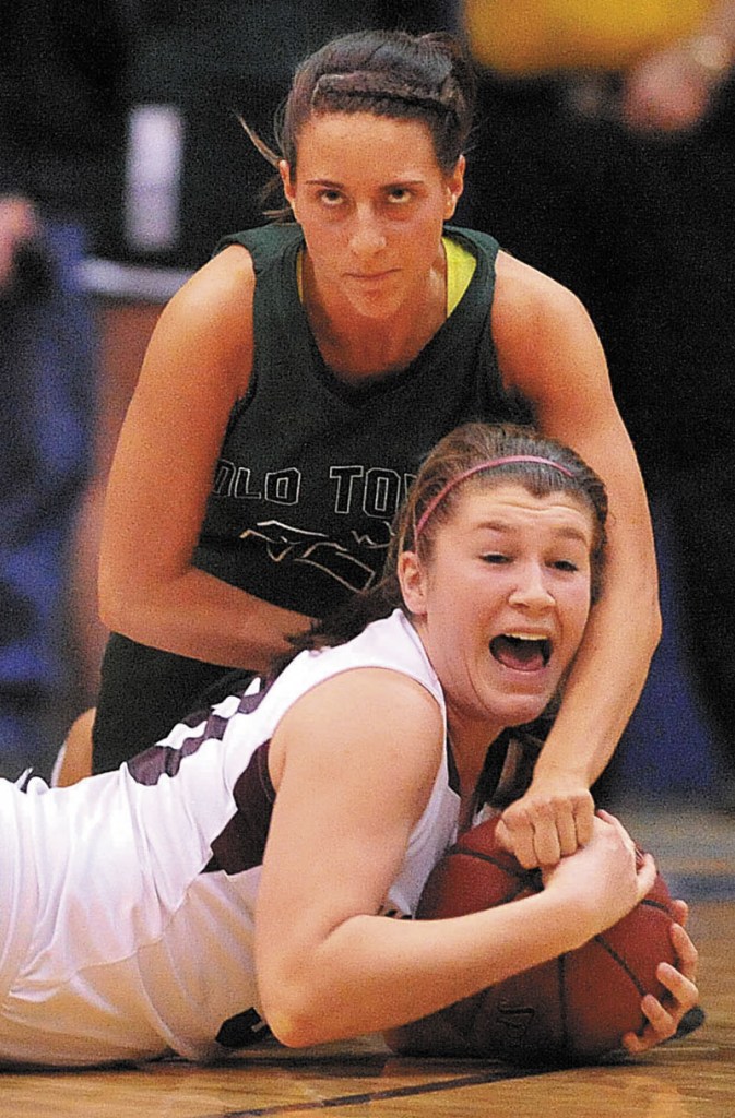 Nokomis High School's Anna Mackenzie, 30, bottom, battles for the loose ball with Old Town High School's Samantha McLaughlin, 22, top, in the second half of the Eastern Class B semi-finals at the Bangor Auditorium Wednesday.