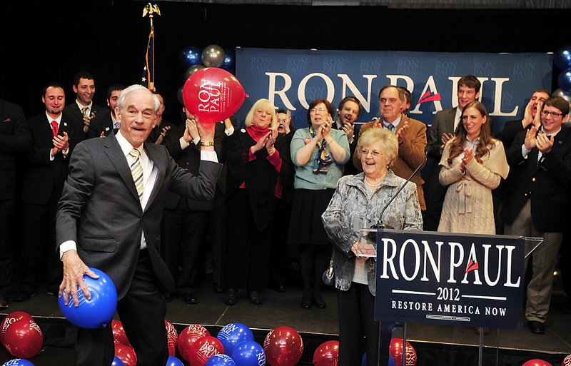 Texas Rep. Ron Paul, a Republican presidential candidate, tosses balloons to supporters Saturday night at the Seasons Event and Conference Center in Portland. Paul came in second to GOP rival Mitt Romney in the Maine GOP’s nonbinding preference poll.