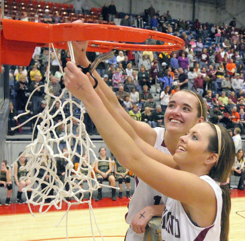 Staff photo by Joe Phelan Richmond captains Jamie Plummer, top, and Danica Hurley cut down the net after the Bobcats won the Western Maine Class D championship on Saturday afternoon at the Augusta Civic Center.