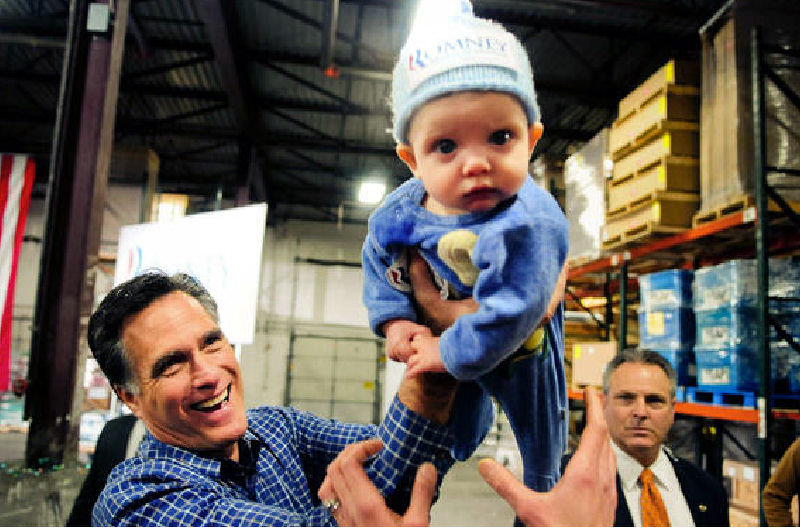 Republican presidential candidate Mitt Romney plays with 6-month-old Dexter Hall of Plymouth, Minn., on Wednesday.