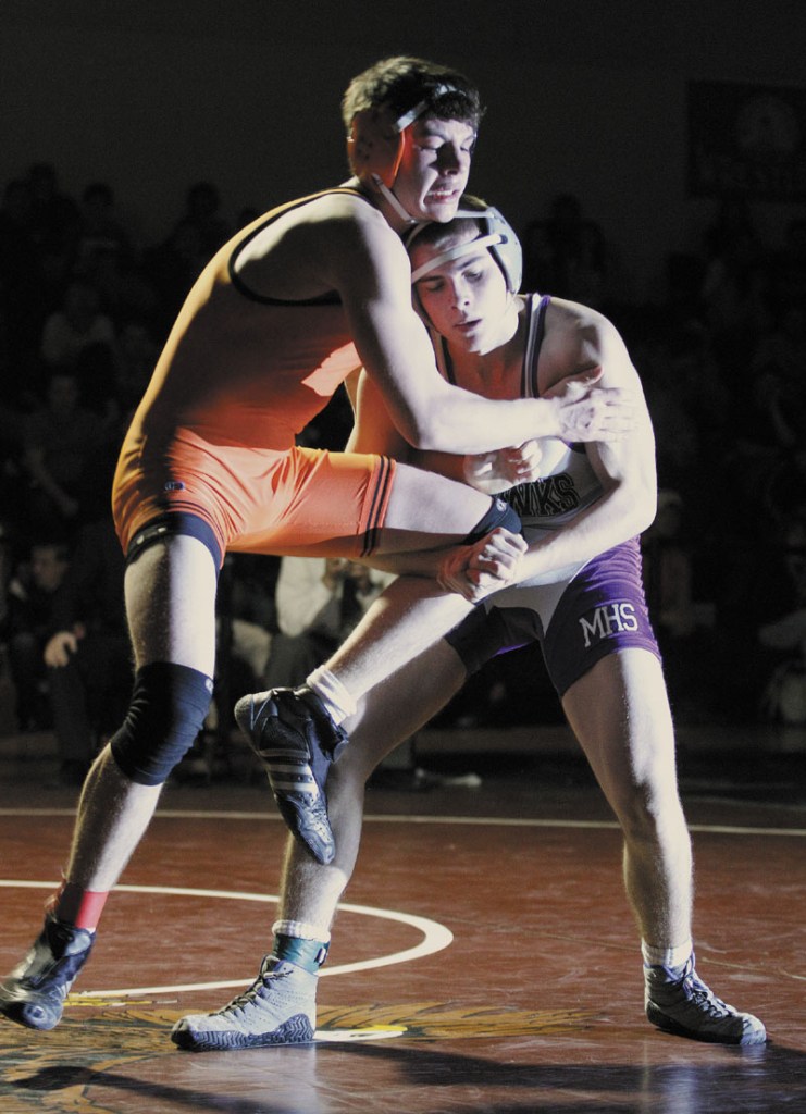 Nicholas Janes of Marshwood, right, tries to take down Skowhegan's Carter Stevens in the 145 pound class during the Class A State Championships.