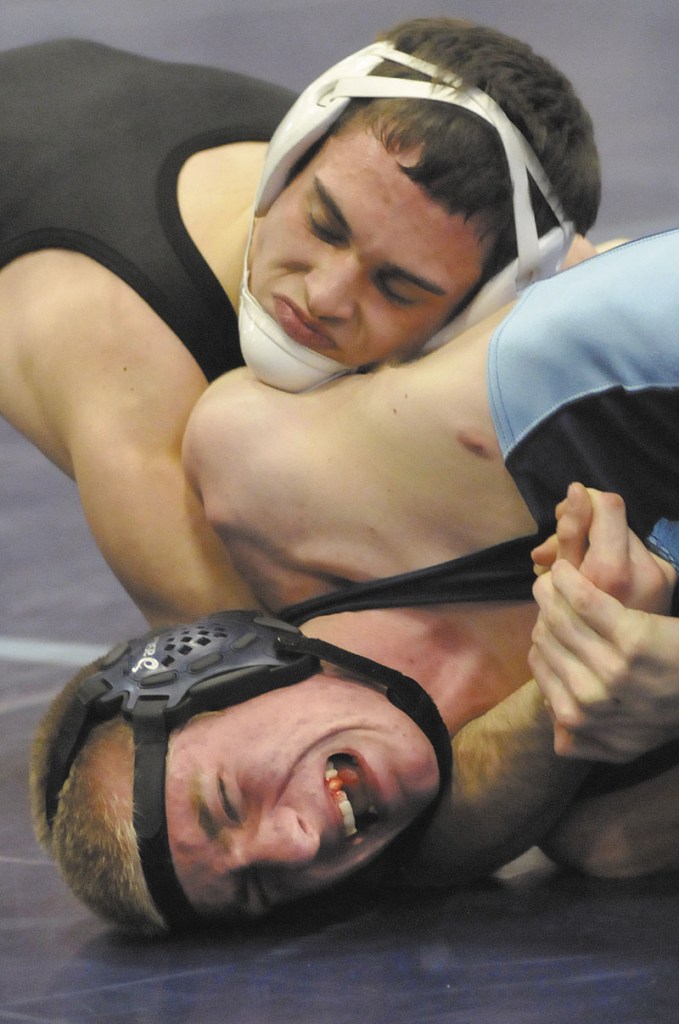 NO ESCAPE: Westbrook’s Cal Randall, bottom, struggles to get out of the grasp of Skowhegan’s Kaleb Brown in a 138-pound match on Saturday in Westbrook. Brown won the weight class and helped Skowhegan to a third-place finish in the Eastern A regional meet.