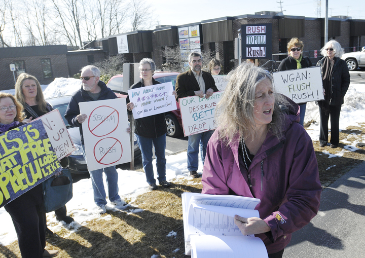 Annie Finch of Falmouth holds a petition calling on radio station WGAN to stop airing "The Rush Limbaugh Show." Finch was joined by a group of supporters outside the Portland Radio Group offices today.