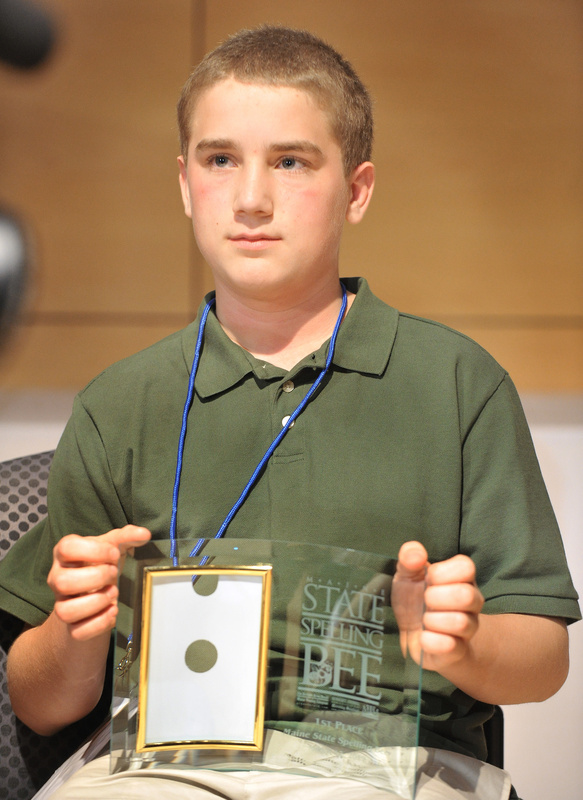 Nat Jordan holds the trophy he won in the annual Maine State Spelling Bee on Saturday.