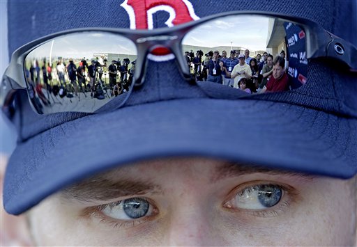 Members of the media are reflected in the sunglasses of Boston Red Sox pitcher Daniel Bard in this Feb. 21, 2012, photo.