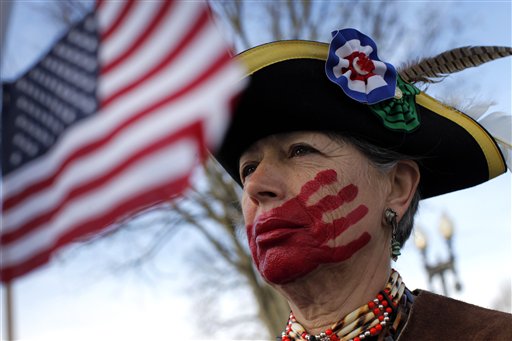 Susan Clark of Santa Monica, Calif., demonstrates outside the Supreme Court in Washington, D.C., today. Clark, who opposes health care reform, says she painted the red hand on her face to represent what she said is socialism taking away her choices and rights.