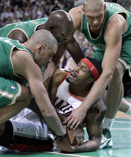 Portland Trail Blazers power forward Craig Smith tries to protect the ball as he is tied up by Boston Celtics forward Sasha Pavlovic, left, forward Kevin Garnett, middle, and center Greg Stiemsma, right, on Friday in Boston.