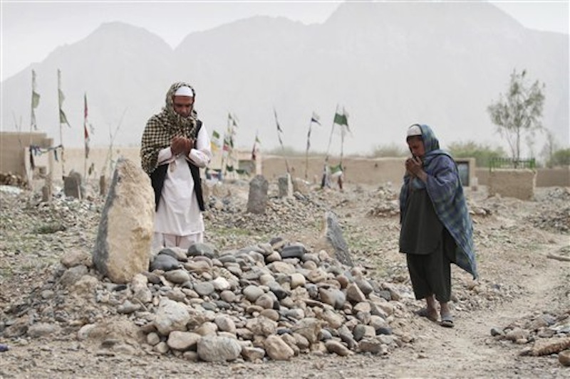 Afghan villagers pray over the grave of one of the sixteen victims killed in a shooting rampage in the Panjwai district of Kandahar province south of Kabul, Afghanistan on Saturday, March 24, 2012. Mohammad Wazir has trouble even drinking water now, because it reminds him of the last time he saw his seven-year-old daughter. He had asked his wife for a drink but his daughter insisted on fetching it. Now his daughter Masooma is dead, killed along with 10 other members of his family in a shooting rampage attributed to a U.S. soldier. The soldier faces the death penalty but Wazir and his neighbors say they feel irreparably broken. (AP Photo/Allauddin Khan)