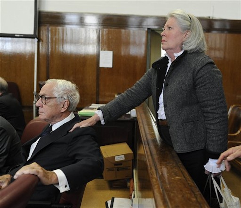 In this Oct. 8, 2009 photo, Charlene Marshall holds the shoulder of her husband, Anthony Marshall, in a courtroom in New York. Brooke Astor's 85-year-old son Marshall was convicted Thursday of exploiting his philanthropist mother's failing mind and helping himself to her nearly $200 million fortune. Elder financial abuse encompasses a wide range of tactics, some perpetrated by relatives or trusted advisers, some by strangers via telemarketing and Internet-based scams. A federal study found that 5 percent of Americans 60 and older had been the victim of recent financial exploitation by a family member, and 6.5 percent by a non-family member. (AP Photo/Steven Hirsch)