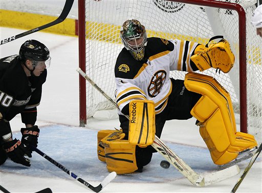 Boston Bruins goalie Marty Turco, right, stops the puck as Anaheim Ducks right wing Corey Perry looks on in the third period of an NHL hockey game in Anaheim, Calif., on Sunday, March 25, 2012. The Bruins won 3-2. (AP Photo/Christine Cotter)