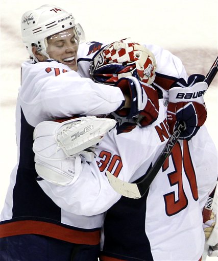 Washington Capitals defenseman John Carlson, left, celebrates with goalie Michal Neuvirth (30), of the Czech Republic, after the Capitals defeated the Boston Bruins 3-2 in a shootout in an NHL hockey game in Boston, Thursday, March 29, 2012. (AP Photo/Elise Amendola)