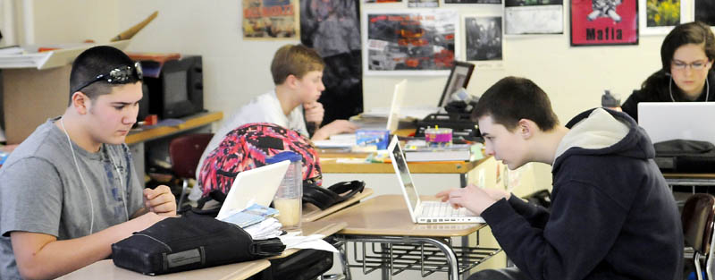 PROFICIENT: Hall-Dale High School students work on a social studies lesson Thursday in Rob Kennedy's classroom in Farmingdale. The entire school district has adopted proficiency-based education, a new education model.