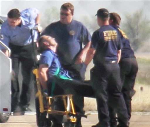 Emergency workers tend to a JetBlue captain that had a "medical situation" during a Las Vegas-bound flight from JFK International airport, Tuesday, March 27, 2012, in Amarillo, Texas. Passengers said the pilot screamed that Iraq or Afghanistan had planted a bomb on the flight, was locked out of the cockpit, and then tackled and restrained by passengers. (AP Photo/Steve Douglas)