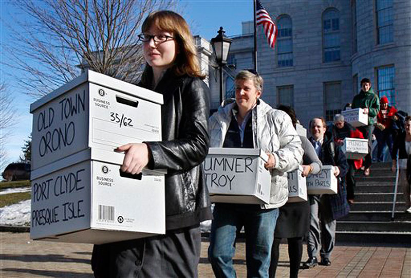 In this Thursday, Jan. 26, 2012 photo, Whitney Gifford, of Bucksport, Maine, leads a group of gay marriage supporters carrying signed petitions to the Secretary of State's office in Augusta, Maine. Foes and supporters of same-sex marriage are gearing up for five costly and bruising statewide showdowns in the coming months of 2012 on an issue that evenly divides Americans. It's an election year subplot sure to stir up heated emotions - even beyond the confines of North Carolina, Minnesota, Maryland, Maine and Washington state. (AP Photo/Robert F. Bukaty)