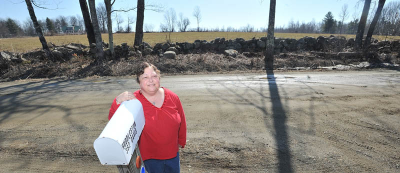 CONCERNED: Debbie Huddleston stands on Davis Road in Farmington in front her residence where a proposed wind turbine station is planned to be built.