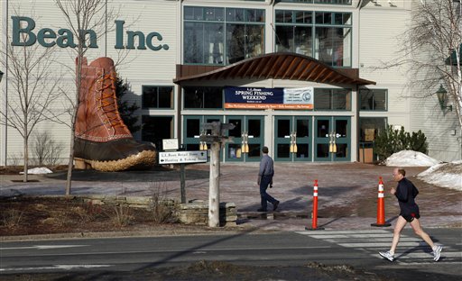 In this March 8 photo, a jogger passes by the entrance to the L.L. Bean retail store in Freeport, Maine. L.L. Bean says sales grew 5.5 percent over the past year despite a mild winter weather that hurt sales of skis, coats and other outdoor gear for which the company is known. (AP Photo/Robert F. Bukaty)