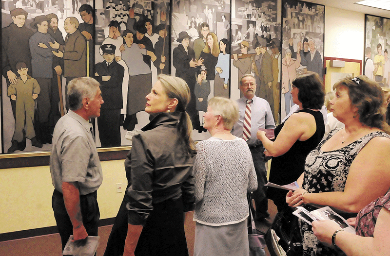 Back in the day: This file photo shows people looking at Judy Taylor’s mural depicting the history of Maine labor while it was on display in the Department of Labor lobby in Augusta, prior to Gov. Paul LePage’s order to have it removed.