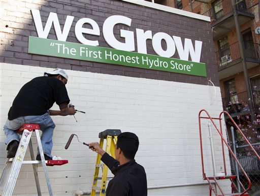 Workers put finishing touches on the exterior of the weGrow store in northeast Washington today in preparation for its Friday opening.
