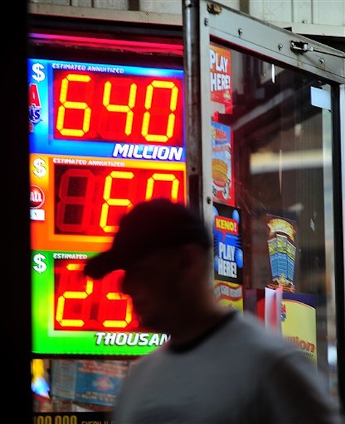 A customer walks out of the Riverside Travel Center in Hilton, Ga., late Friday night after purchasing a lottery ticket for the Mega Millions Lottery which reached an estimated record jackpot of $640 million for Friday night's drawing. (AP Photo/Jay Hare, The Eagle) MEGAMILLIONS LOTTERY