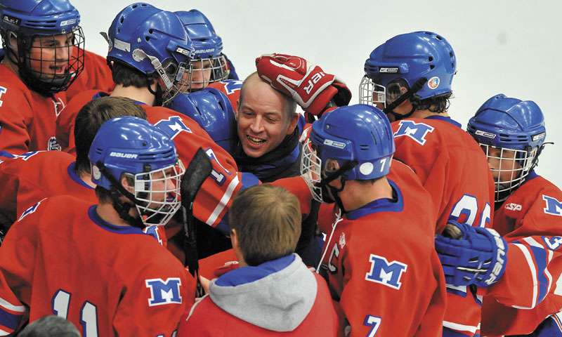 WAY TO GO: Messalonskee players celebrate around head coach Mike Latendresse after they won the Eastern Maine Class B title with a 5-2 win over Brewer on Tuesday night at the Unviersity of Maine in Orono.