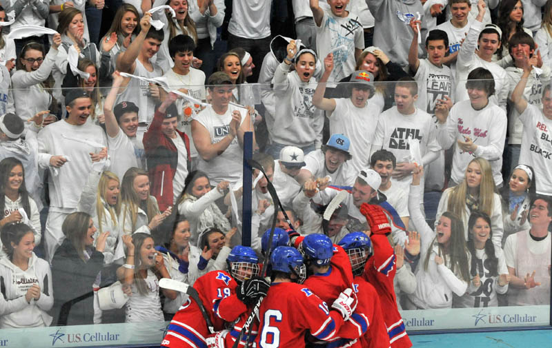 Photo by Michael G. Seamans Messalonskee High School hockey players celebrate a goal in front of the student fans in the second period of the Class B East hockey regional finals at Alfond Arena at the University of Maine in Orono Tuesday night.