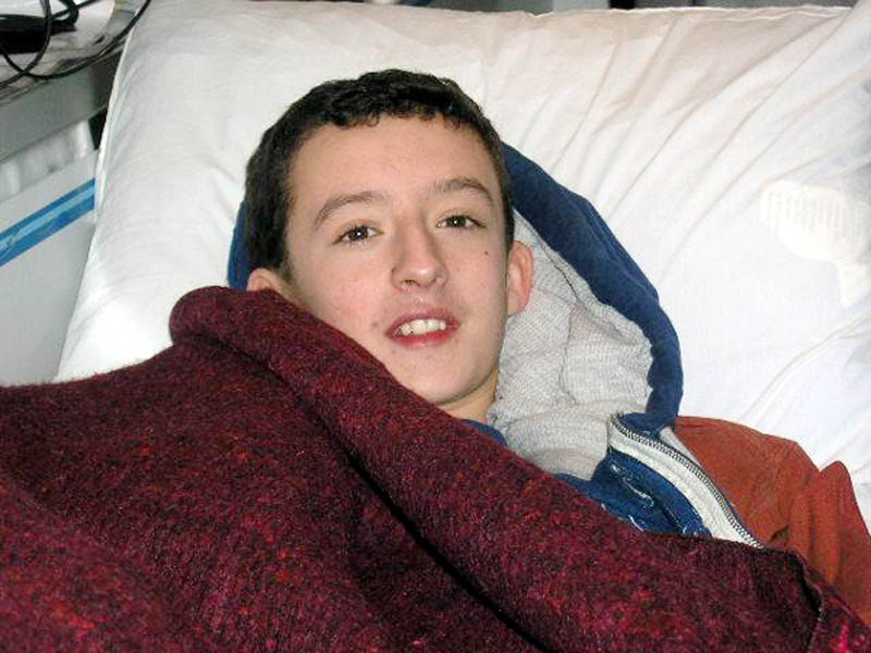 FOUND: Micah Thomas, 12, of Dresden, in an ambulance on Thursday after being found near a smelt shack. The boy's family expects him to make a full recovery after spending Wednesday night in the woods.