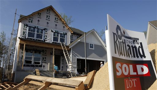 Builders work on a new home in Mechanicsville, Va., today. Sales of U.S. new homes fell in February for the second straight month, a reminder that the depressed housing market remains weak despite some improvement.