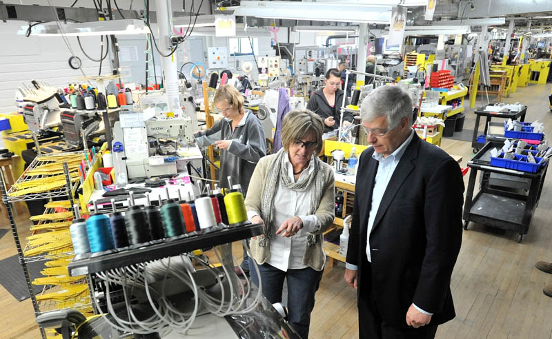 New Balance plant manager, Raye Wentworth, center, gives a tour of the factory to Rep. Mike Michaud this morning.